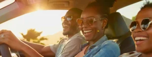 a vibrant summer road trip scene captures a joyful family laughing together in a sleek car as they cruise along a sun-drenched highway lined with lush greenery.