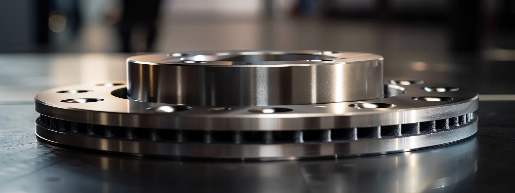 a close-up photo of a shiny brake rotor and caliper, showcasing their essential role in the vehicle's safety and performance.